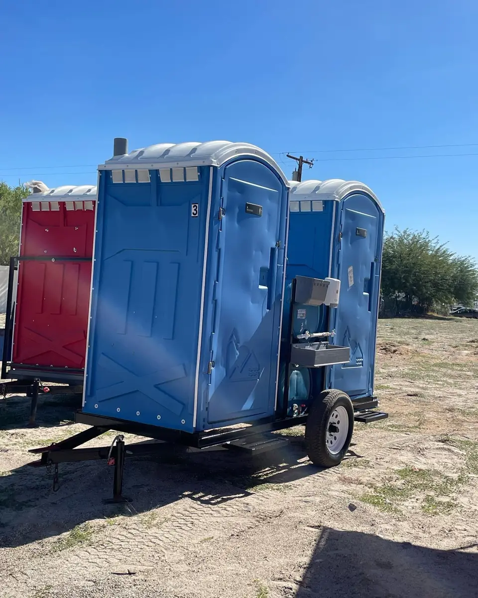 Porta potties loaded on a Cory Rental Works delivery trailer